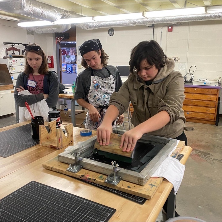 a student learns to screen print 